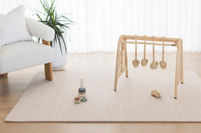 rch / River Bend baby play mat in a neutral living room with a wooden play gym and toys