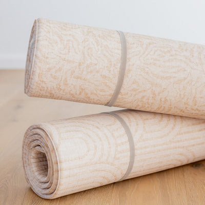 Two rolled Arch / River Bend play mats stacked horizontally and secured with grey straps